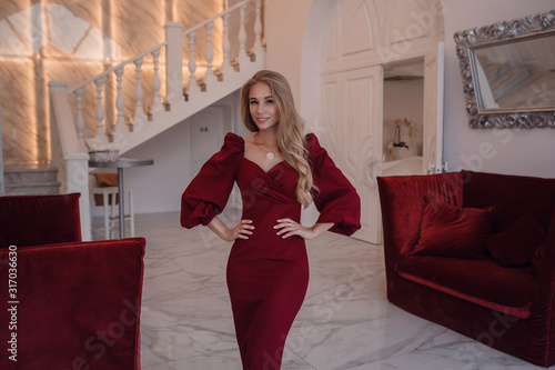 romantic portrait of elegand blond woman waiting for someone in a luxury restaurant photo