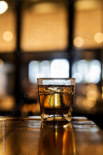 Whisky In A Glass. Light Bokeh Background. Out Of Focus.