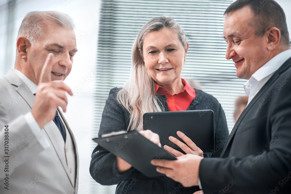 project Manager discussing working documents with colleagues project Manager discussing working documents with colleagues
