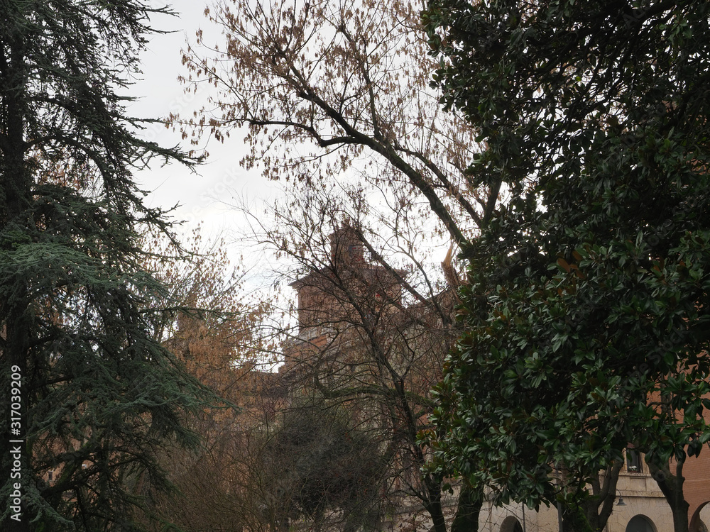 Ferrara, Italy. The castle beyond the trees of the public park. Ferrara, Italy. The castle beyond the trees of the public park.