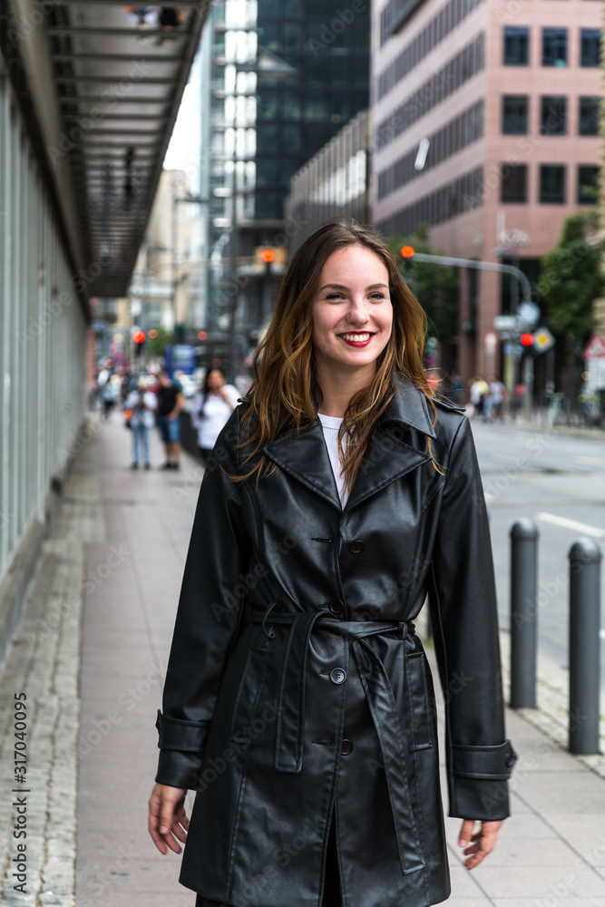 Attractive Young Woman in Black Trench Coat