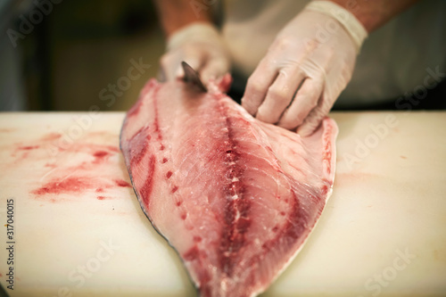 Filleting fish at fish market 