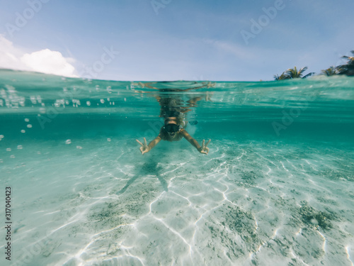 Carefree female submerged at oceania shallow happy from spending free time for Indonesian holidays  happy woman in snorkel mask enjoying recreation in underwater during scuba diving for explore sea