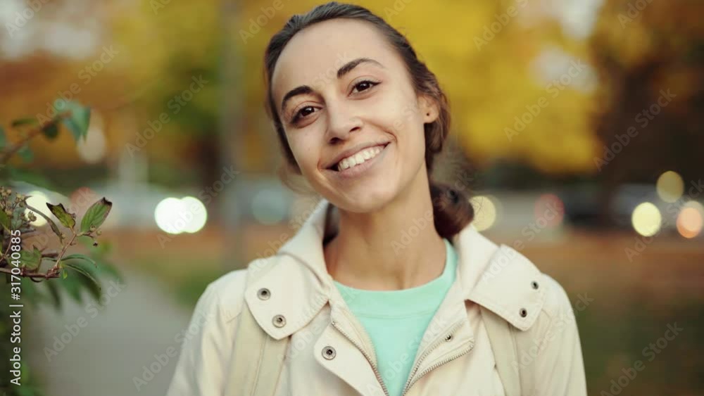closeup of pretty young smiling woman walking in the autamn park. girl enjoying warm autumn evening outdoors in colorful yellow fall park, 4k stock footage closeup of pretty young smiling woman walking in the autamn park. girl enjoying warm autumn evening outdoors in colorful yellow fall park, 4k stock footage