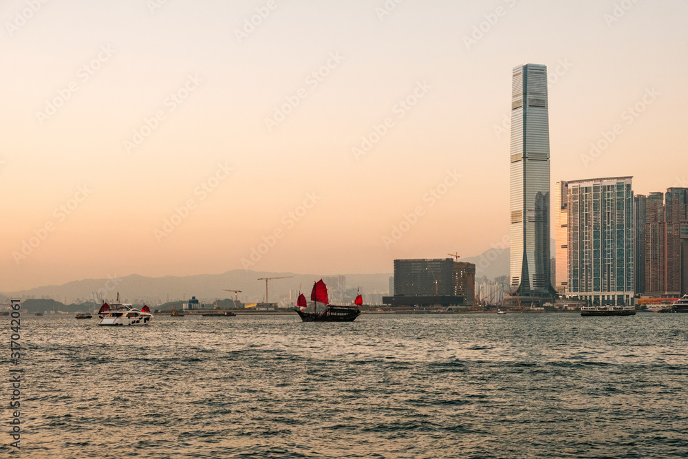 Seascape and cityscape of HongKong, Kowloon and Victoria Harbour with ships, sailboats and city skyline