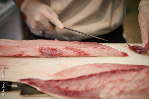 Filleting fish at fish market 