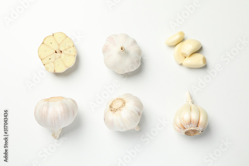 Flat lay with garlic bulbs on white background, top view photo