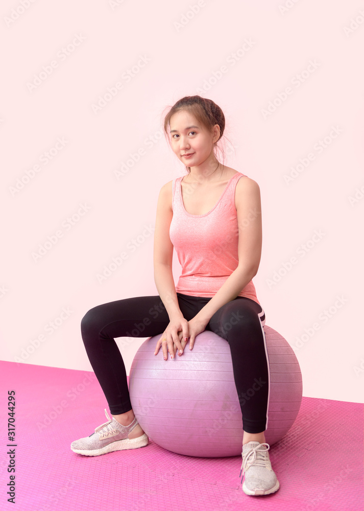 Cute asian woman doing gymnastic exercises with balls Cute asian woman doing gymnastic exercises with balls