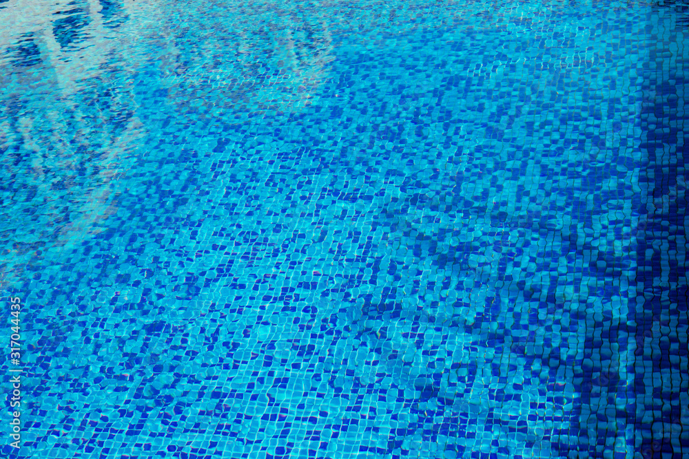 Abstract background of blue water surface in swimming pool.