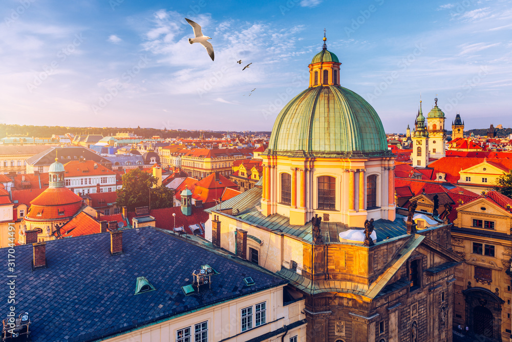 Aerial panorama view with flying birds of the Old Town in Prague, Czech Republic. Red roof tiles panorama of Prague old town.  Prague Old Town Square houses with traditional red roofs. Czechia.