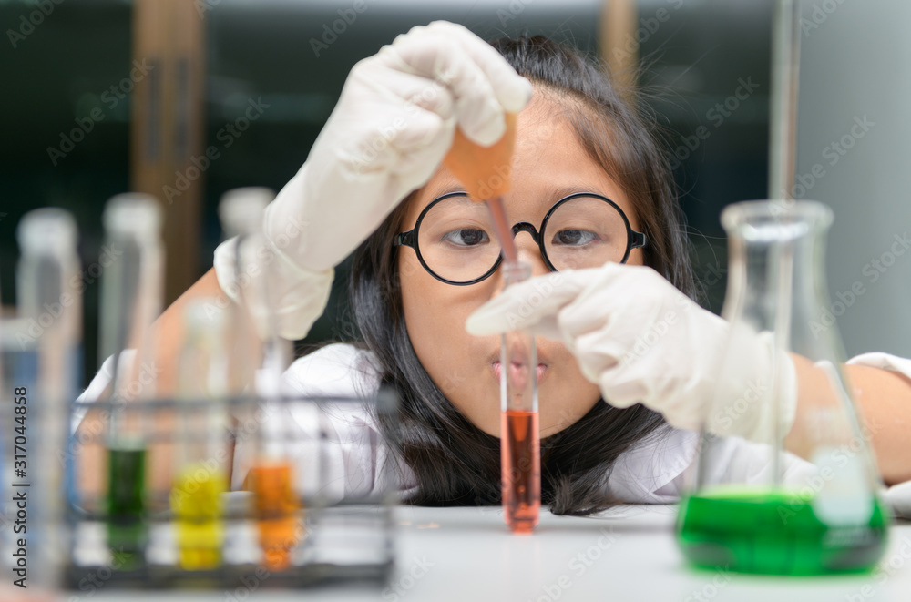 Little scientist use dropper to making experiment. Little scientist use dropper to making experiment.
