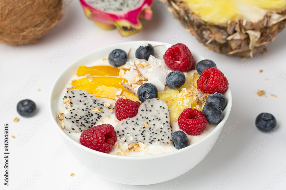 Smoothie bowl with mango, pineapple, dragon fruit, blueberries, raspberries and coconut. Delicious and healthy Breakfast. Smoothie bowl with mango, pineapple, dragon fruit, blueberries, raspberries and coconut. Delicious and healthy Breakfast.