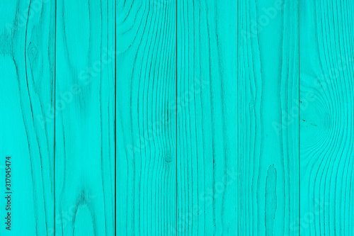 The texture of green from old wooden planks arranged in a vertical order.