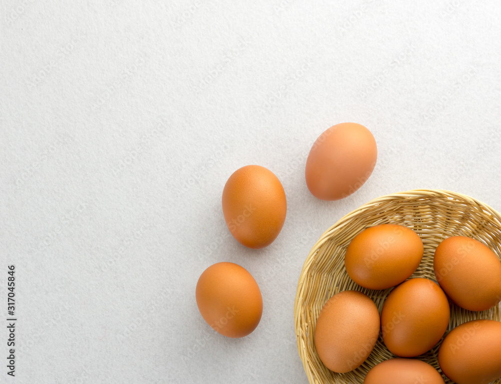 Eggs placed in a woven wooden basket.