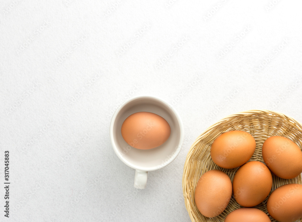 Eggs placed in a woven wooden basket.