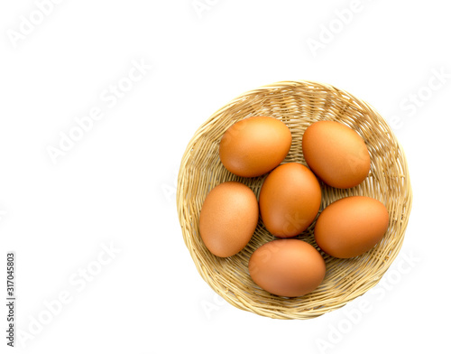 Eggs placed in a woven wooden basket.