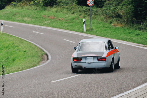 Blur background old vinatge retro european race car on the road back view