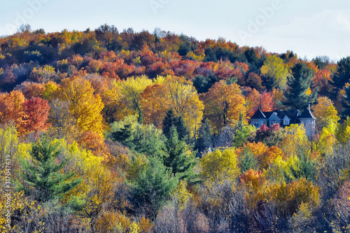 A house during a beautiful autumn in the mountains. Indian summer in Quebec Canada