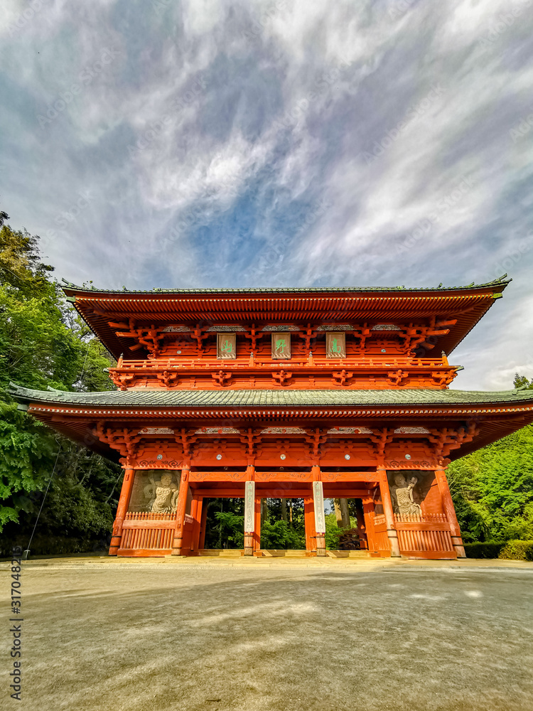The vibrant red Daimon gate functioning as the entrance to the famous pilgrimage town Koyasan in Wakayama, Kansai, Japan. The vibrant red Daimon gate functioning as the entrance to the famous pilgrimage town Koyasan in Wakayama, Kansai, Japan.
