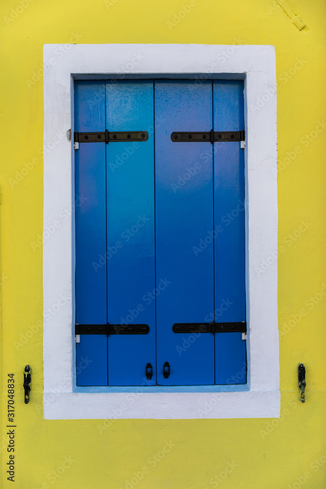 Colorful window of a house on the Venetian island of Burano, Venice. Facade of the houses of Burano close-up. Venice, Italy.