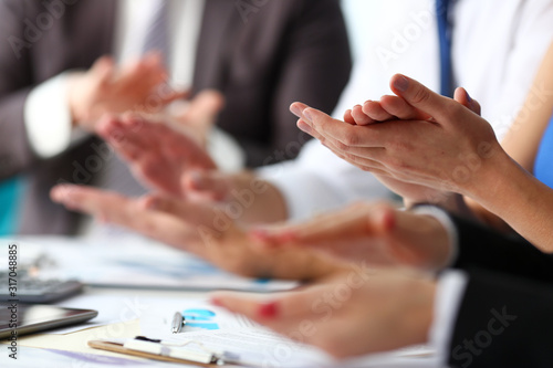 Group of people clap their arm in row during seminar closeup. Great news brief achievement win deal good job happy birthday employee introduce party positive welcome effective speech concept photo