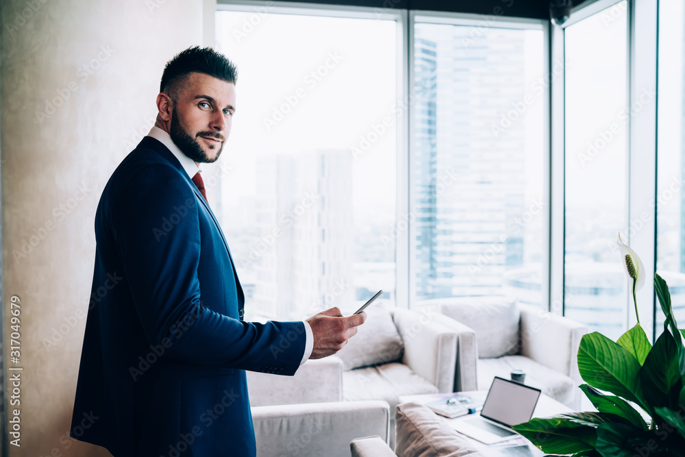 Contemporary employee using device at office Contemporary employee using device at office