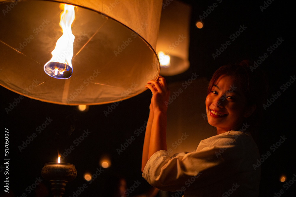 Thai Asian woman holding Yi Peng lantern