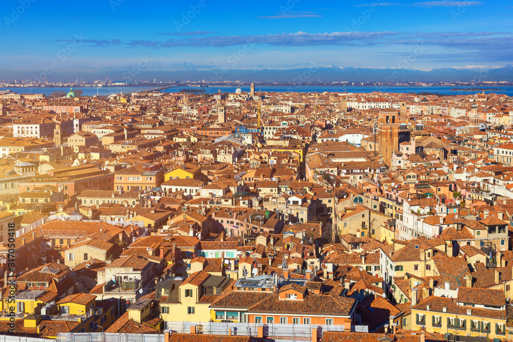Fototapeta premium Venice panoramic aerial view with red roofs, Veneto, Italy. Aerial view of the Venice city, Italy. Venice is a popular tourist destination of Europe. Venice, Italy.