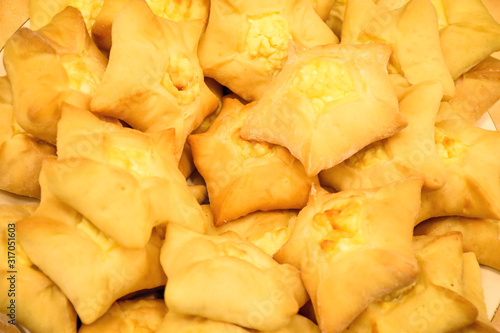 Closeup traditional Asian cuisine – homemade star-shaped pastry filled with curd or cottage cheese (selective focus)