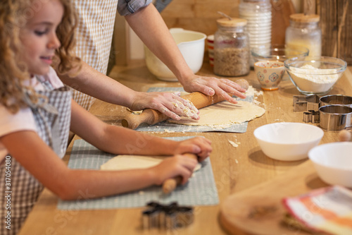 Mother and daughter playing and preparing dough in the kitchen.Family concept.Retro kitchen design. 