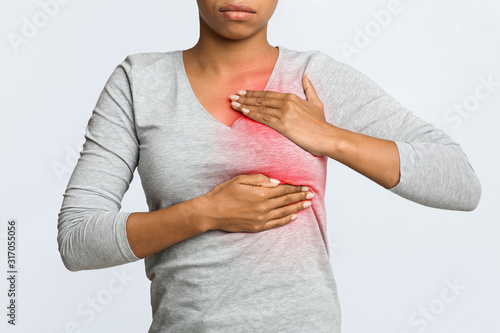 Photography Close up of young woman pulping her breast
