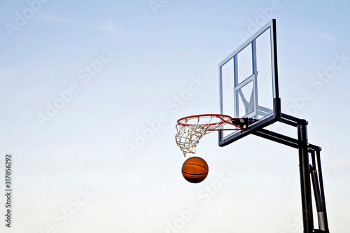 Basketball that has just passed through the hoop © lindahughes