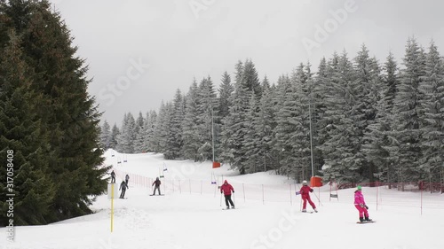 Reacreational skiing in mountain ski resort. Winter landscape. photo