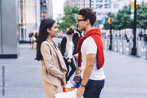 Romantic couple talking on pavement in megapolis