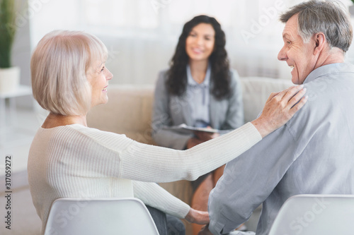 Happy mature couple reconciling after successful therapy