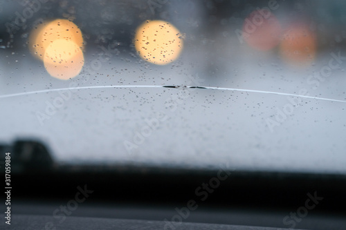 Crack from a pebble on a car windshield. Broken glass auto.