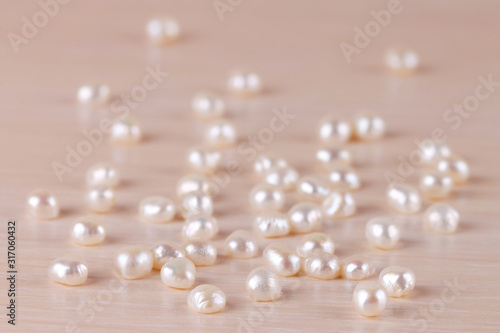 The white river pearls are scattered on the table. Jewelry.