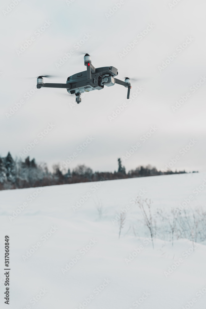 Running drone into the sky, quadcopter on blue sky background. Running drone into the sky, quadcopter on blue sky background.