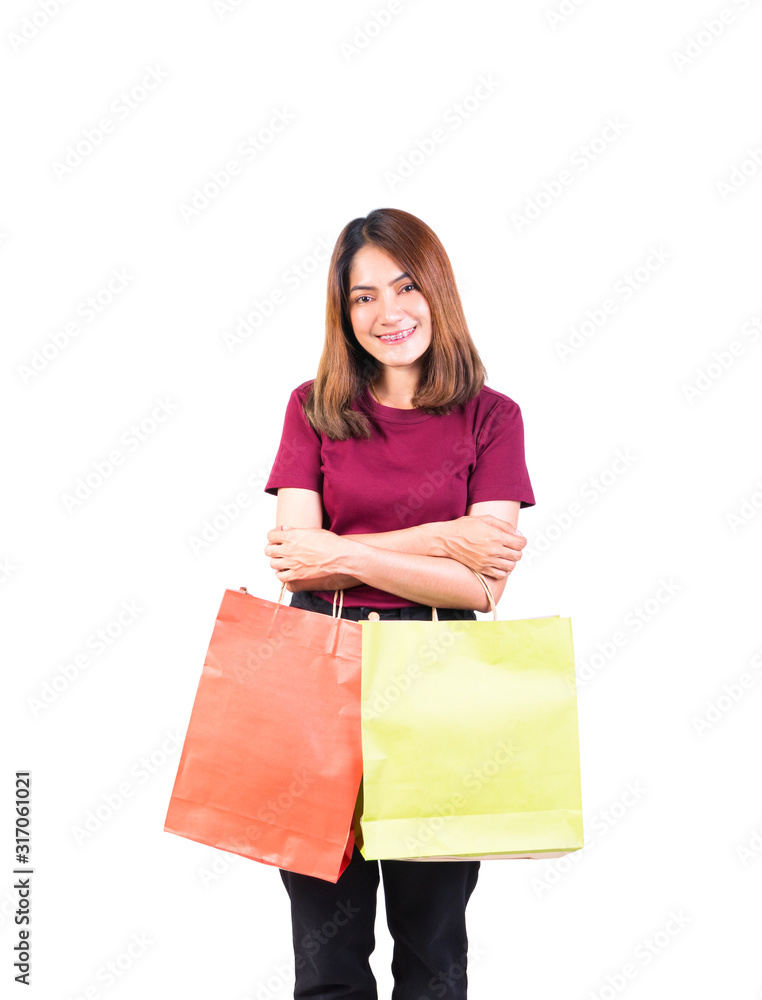 young woman pretty smiling holding paper bags green and orange shopping. on white background and looking at camera young woman pretty smiling holding paper bags green and orange shopping. on white background and looking at camera