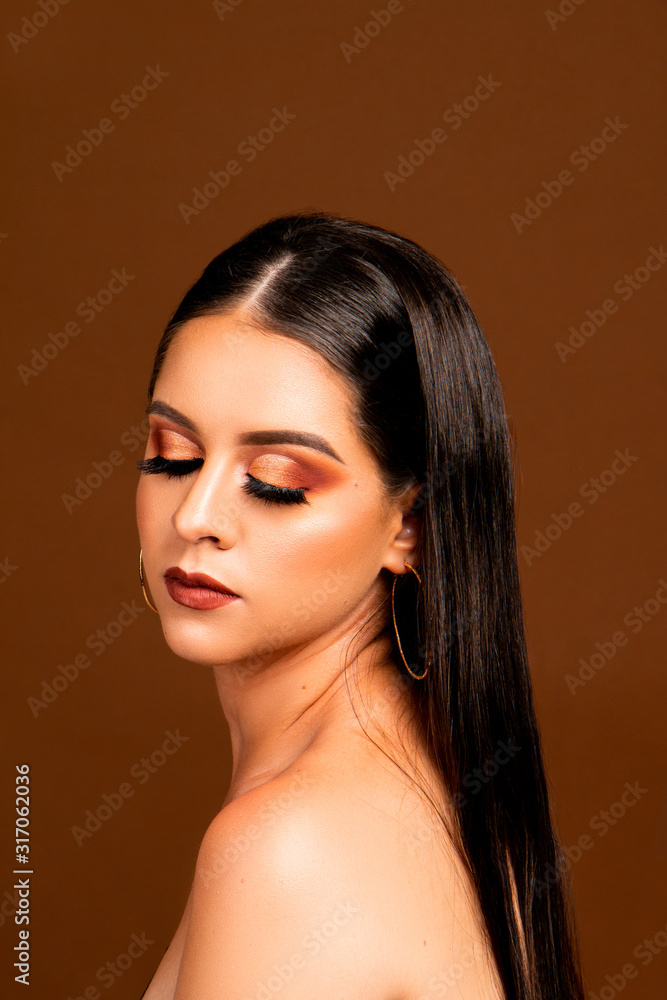 Makeup woman with straight hair and brown background Makeup woman with straight hair and brown background