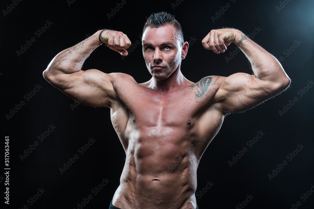 Male bodybuilder with an athletic build on a dark background.athlete, exercise, health, power, strength, man,