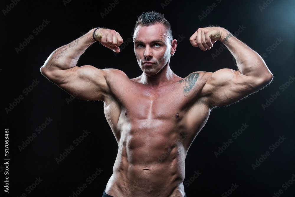 Male bodybuilder with an athletic build on a dark background.athlete, exercise, health, power, strength, man, Male bodybuilder with an athletic build on a dark background.athlete, exercise, health, power, strength, man,