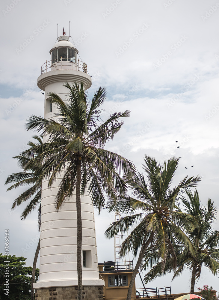 Lighthouse at Galle Fortress in Sri Lanka for palm trees