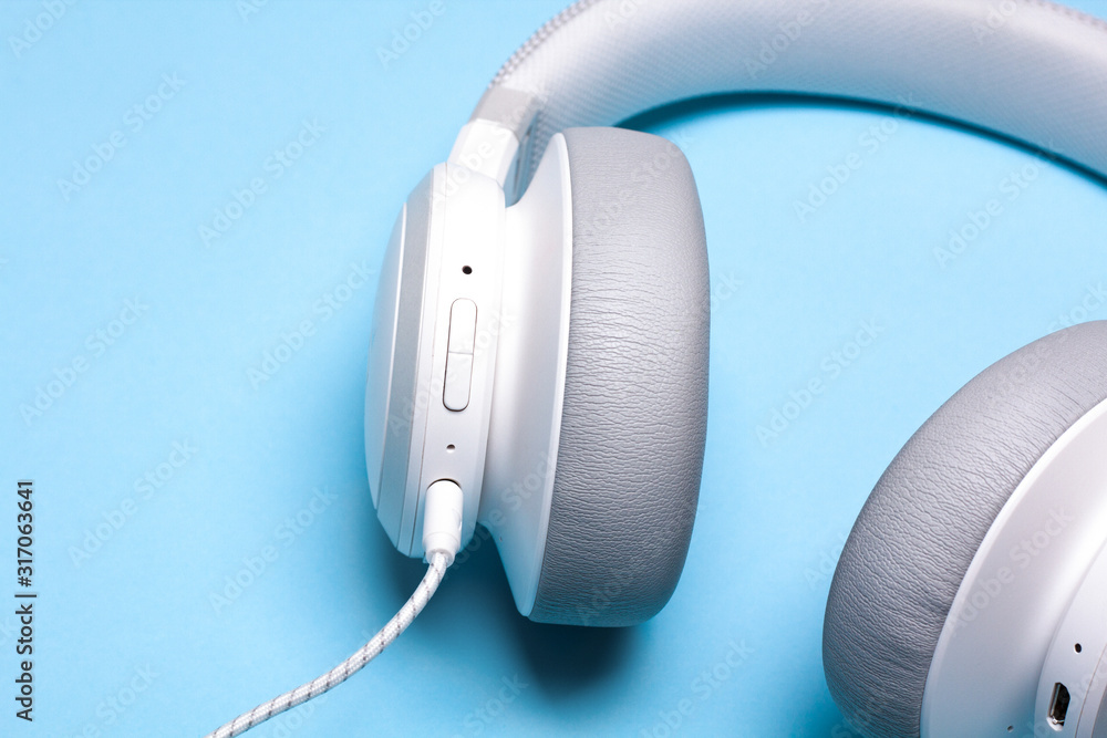 Headphones on blue background. Music concept.