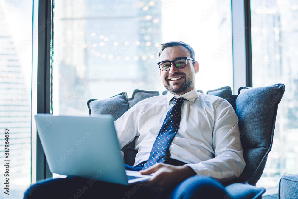 Successful boss watching laptop at workplace Successful boss watching laptop at workplace