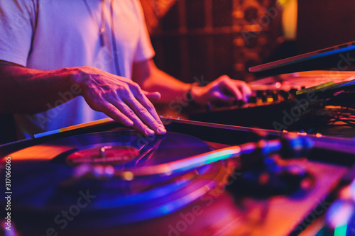 Fotografie Dj mixer and Vinyl Player at club. Soft focus.
