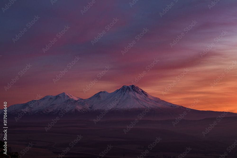 Fototapeta premium Snowy Mount Hasan Volcano Anatolia Turkey Aksaray Sunset Pink Red Orange Sky