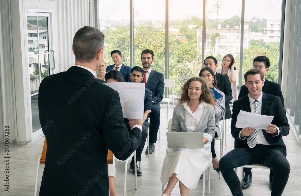 Speaker Giving a Talk at Business Meeting. Audience in the conference hall. Business and Entrepreneurship Speaker Giving a Talk at Business Meeting. Audience in the conference hall. Business and Entrepreneurship