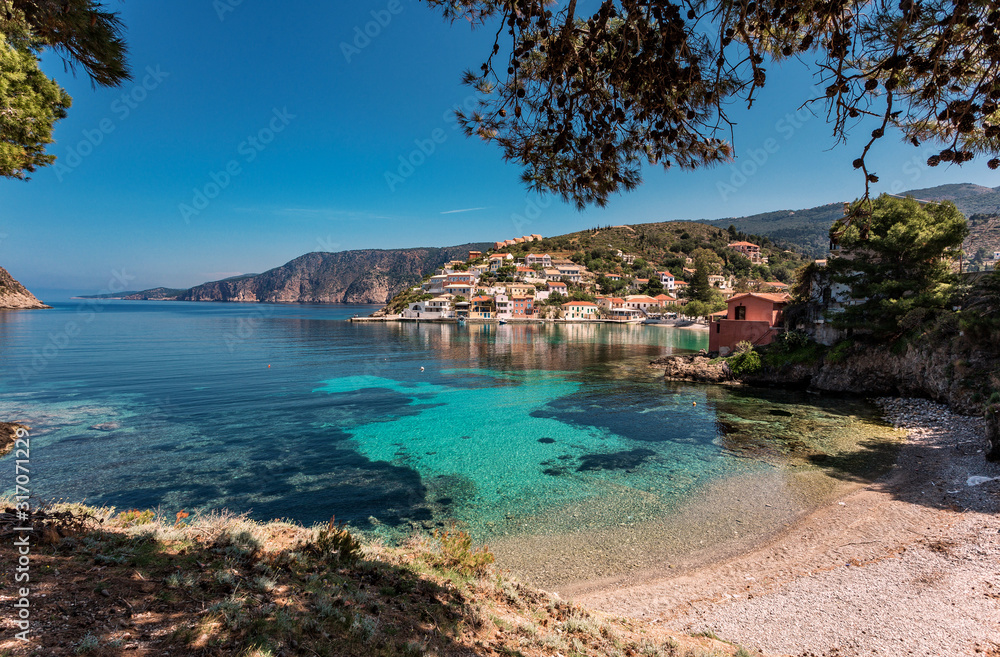 Splendid sunny view on Famous buhts with turquoise water in Ionian Sea.  Incredible nature siascape. Amazing Greece - picturesque colorful village Assos in Kefalonia.