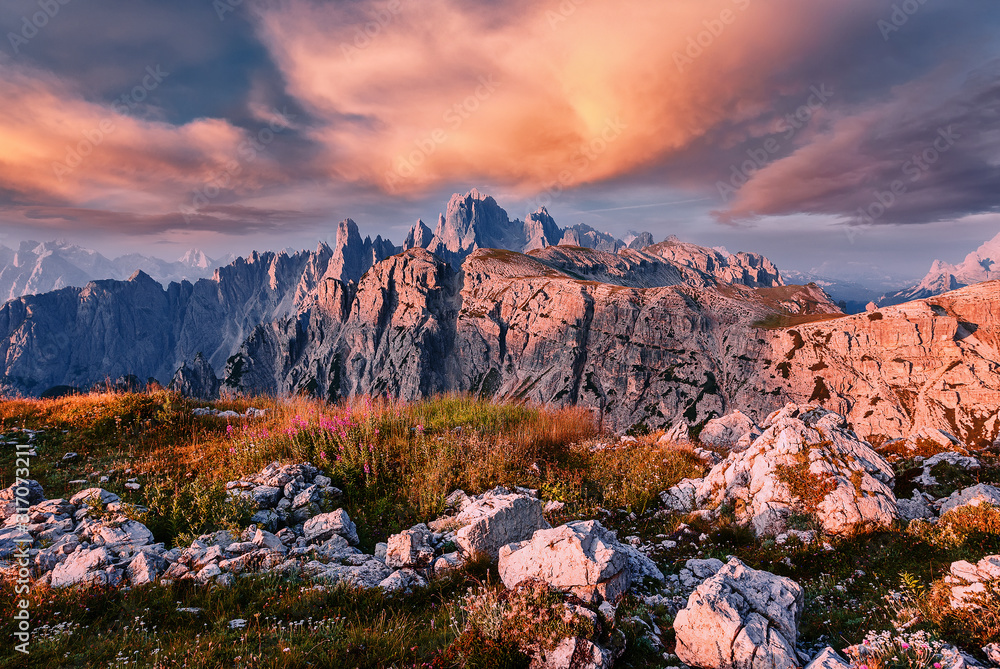 Wonderful nature landscape with colorful sky in spring. Awesome Dolomites Alps during Sunset. Famouse hiking place in dolomite mountains, Tre cime di Lavaredo national park popular travel destination.